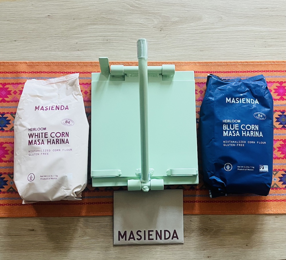 Masienda equipment (tortilla press) and masa harina (heirloom white and blue corn)