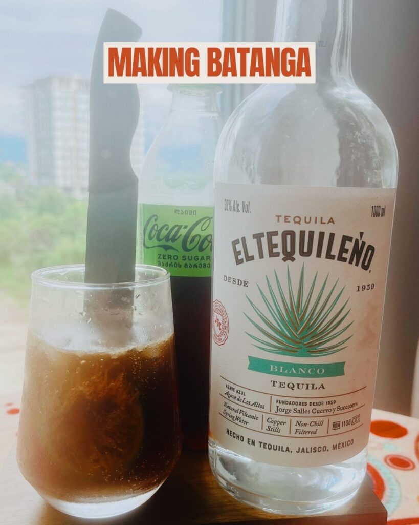 making Batanga cocktail with tequila and coke