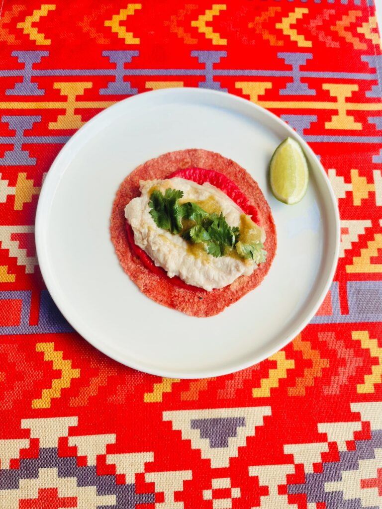 Gaonera de cerdo taco on a beetroot-infused corn tortilla and tkemali-jalapeno salsa