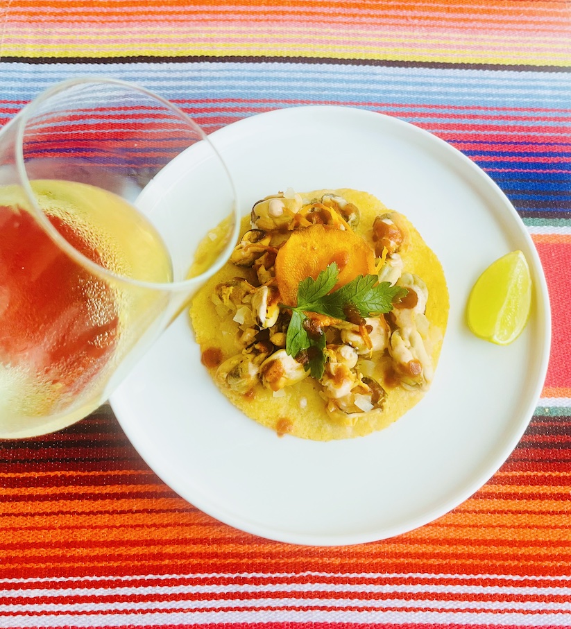 mussels tostada and glass of wine 