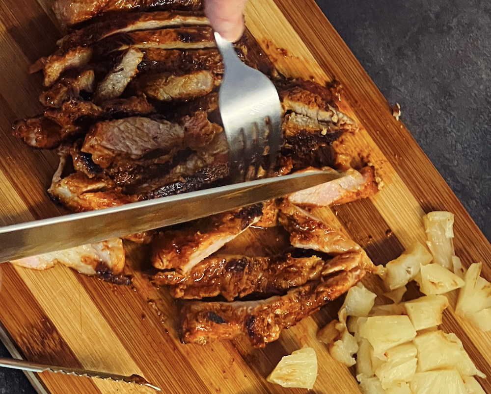 cutting Al Pastor meat for Gringa tacos